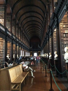Saturday morning I took my librarian pilgrimage to the Trinity College Library and a viewing of the Book of Kells. Unlike the Wren Library, that still was a functioning research space, Trinity Library's Long Room is mainly a storage for rare and old books (200,000) and a hall that has given way for tourists. Still a beautiful sight to behold. It was completed in the 1730s; the roof was raised (the beautiful curved ceiling) was added to accommodate more books in the 1850s. The Book of Kells was published in AD800 and contains the four gospels of the New Testament. They have a rotating two pages displayed for the public at any one time. (so I saw the Page of Kells)