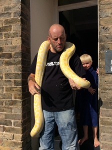 We happened upon a man standing in the sun on his front steps (son behind him) holding his pet albino boa constrictor. We had a long chat and now I know more than I want to know about these strange creatures (the pet owner included). He has about 12 others inside the house, though this is the only albino! 